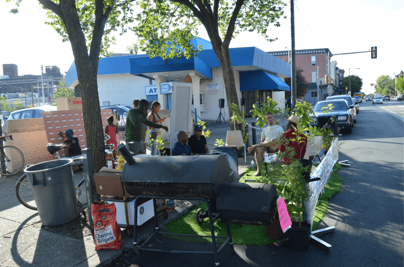 Community members gather for a barbecue outside the United Bank building.