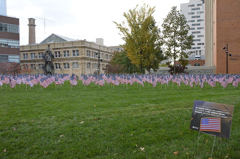 The view of the flag installation from outside of the Gerri C. LeBow Hall.
