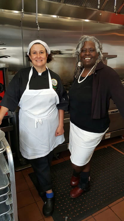 Marjore Felton standing with Valerie Erwin in the kitchen of the EAT Cafe