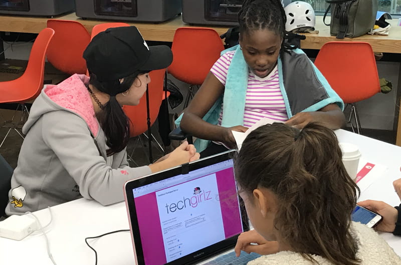 Three middle school girls at a technology workshop