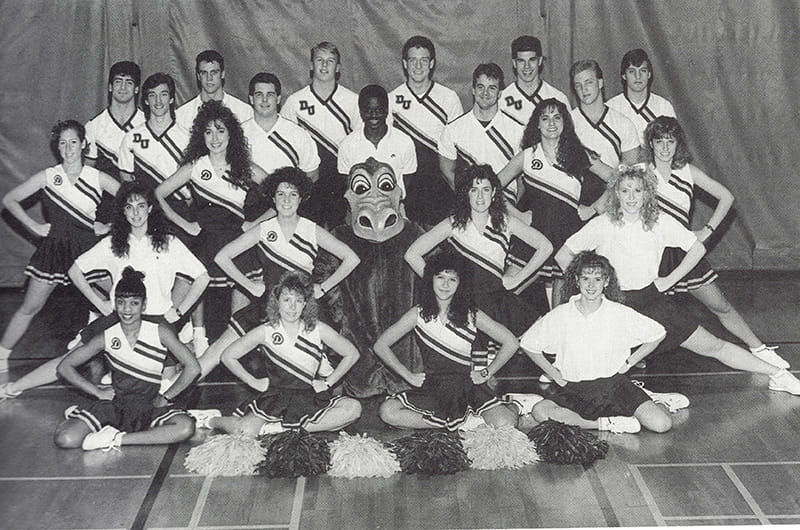 The Drexel Dragon posing with the University's cheer squad in the 1990 yearbook. Photo courtesy University Archives.