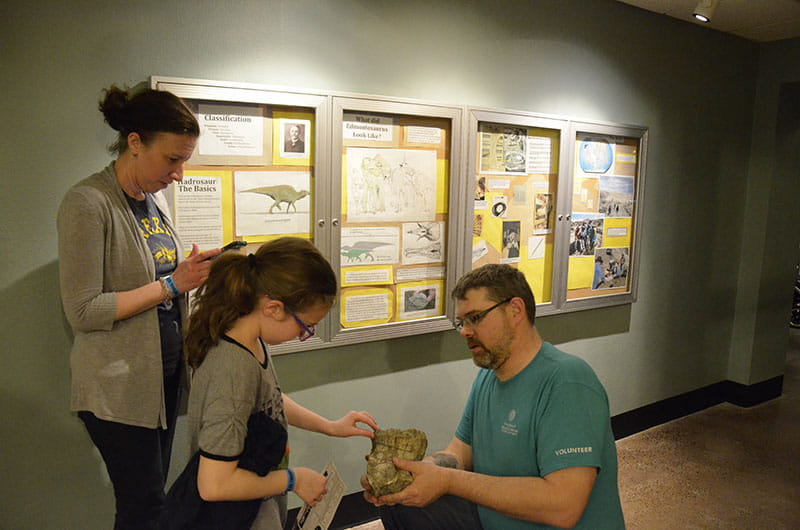 One child had the opportunity to touch and feel a real-life dinosaur fossil at the Academy of Natural Sciences during Drexel's Inspire a Child to Dream event.