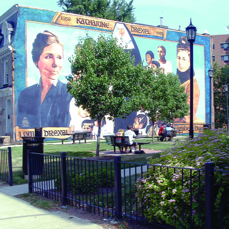 The former “Katharine Drexel Park” located on what is now Race Lawn before the building was taken down. Drexel’s University City Campus used to have a mural on an apartment that was decorated with images of Saint Katharine and her two biological sisters. 