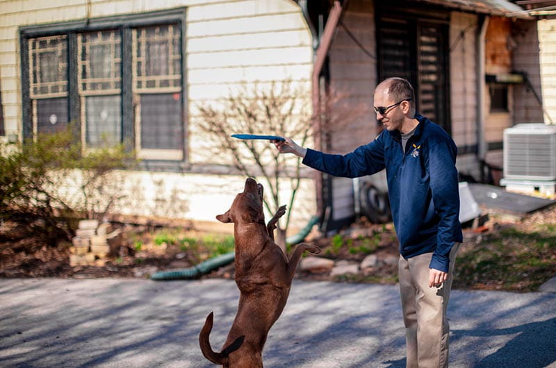 David Florio and his dog, Maddie, playing in the driveway of the Button. 