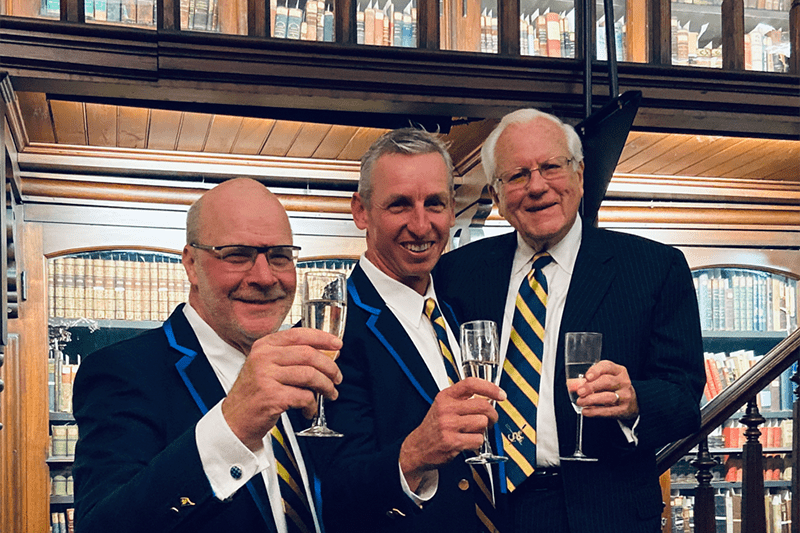 Go Dragons — a toast to 2020! From left: Athletics Director Eric Zillmer, Director of Rowing Paul Savell and Trustee Emeritus and Drexel alumnus George Krall. 