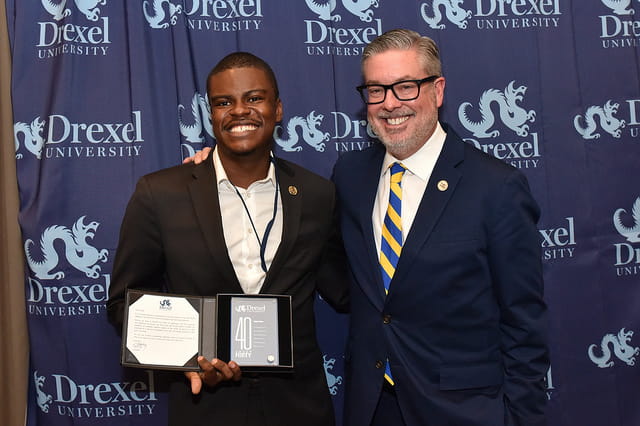 Jabari Jones, left, and Drexel President John Fry in 2016, when Jones was honored for being one of Drexel Magazine's "40 Under 40" awardees.