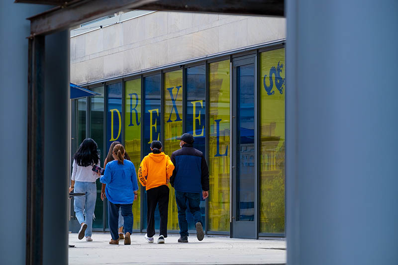 A group strolls by MacAlister Hall on Drexel's University City Campus during a "Walking Tour Weekend!" event in April 2021. Photo credit: Jeff Fusco.