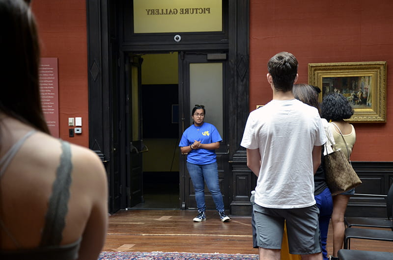 Esta Jacob, a rising second-year finance and legal studies major and student ambassador, starts a campus tour in the AJ Drexel Picture Gallery.