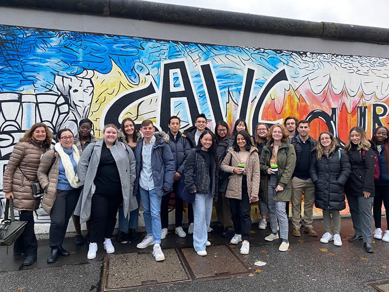 Students from a global classroom led by Clinical Professors of Business Dana D'Angelo and Jodi Cataline visit academic partners in Berlin. Here they visit the Berlin Wall at the East Side Galley. Photo courtesy of D'Angelo.