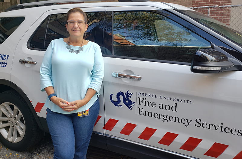 Madonna Calderoni in front of a Fire and Emergency Services vehicle.