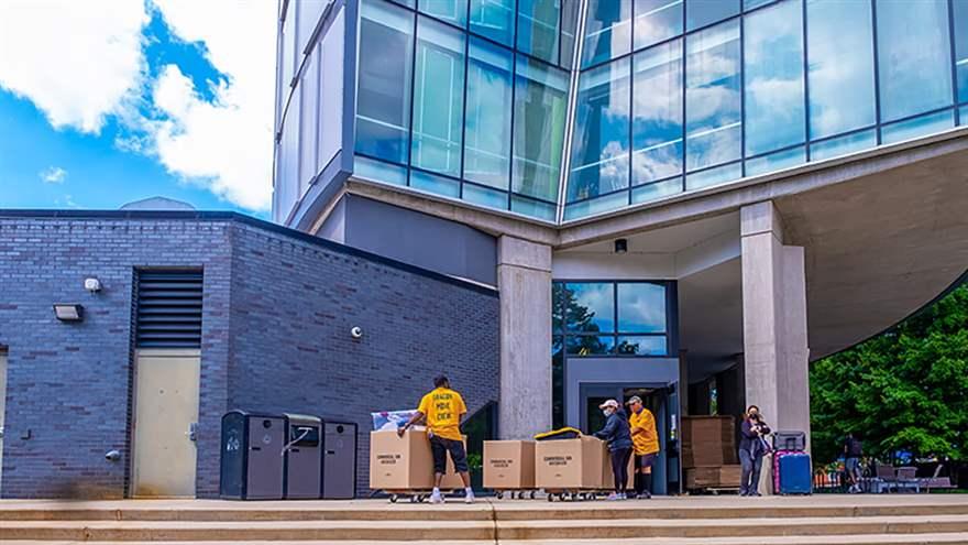 Crews from University and Student Services (USS) move student belongings into Millennium Hall on Sept. 10. Photo by Jeff Fusco.