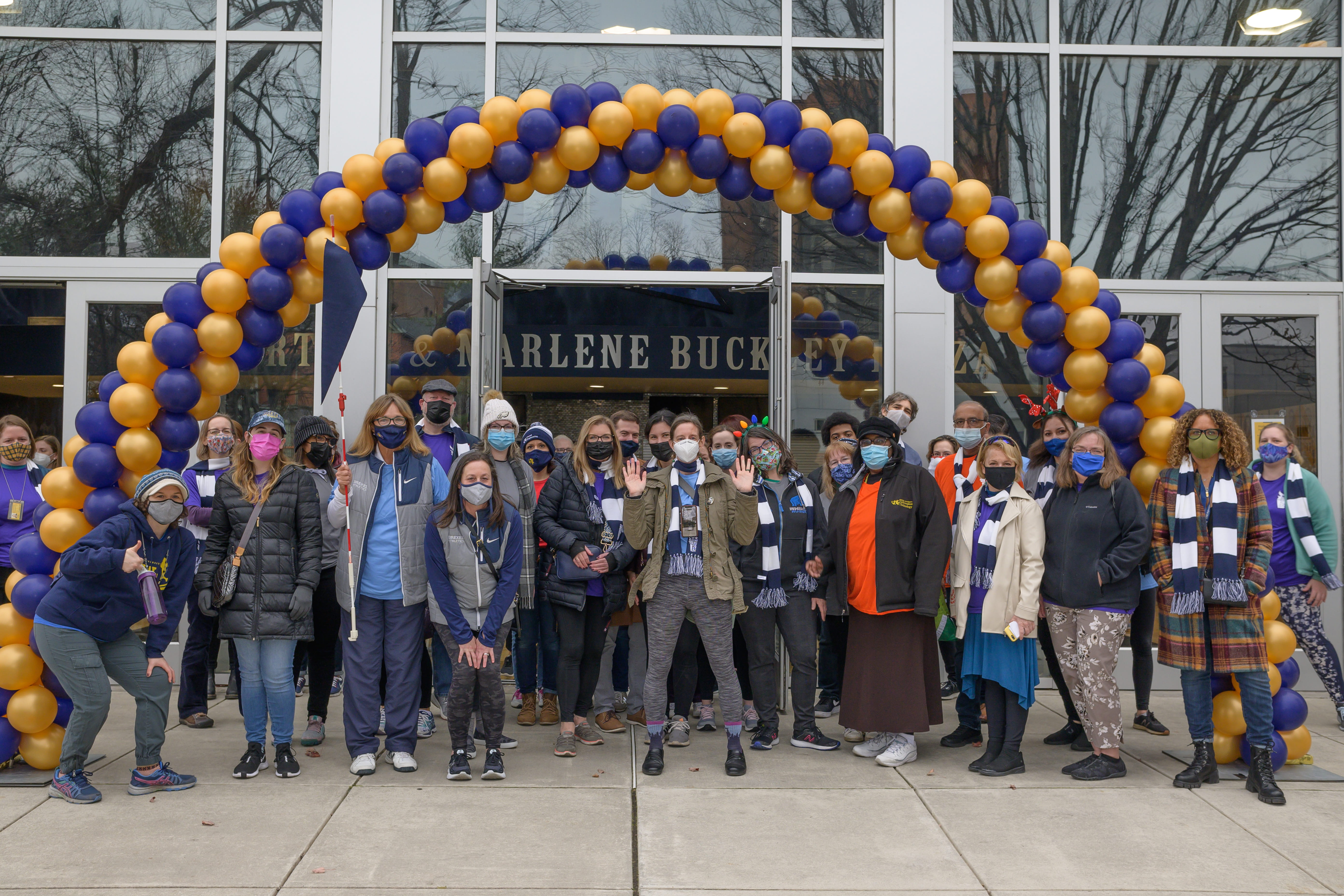 Drexel employees gathered under a balloon archway. 
