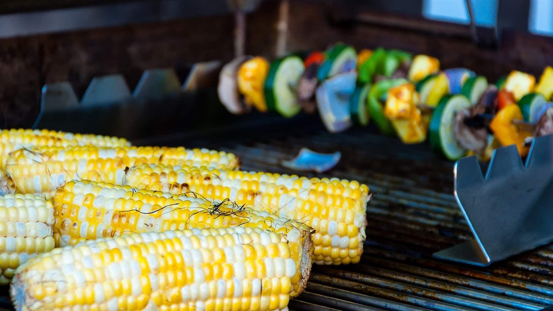 An image of summer corn and zucchini skewers on the grill.