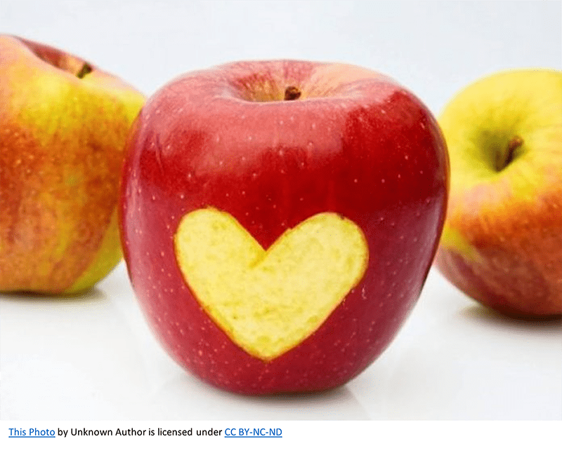 Photo of apples, with centered apple with a heart peeled into it.