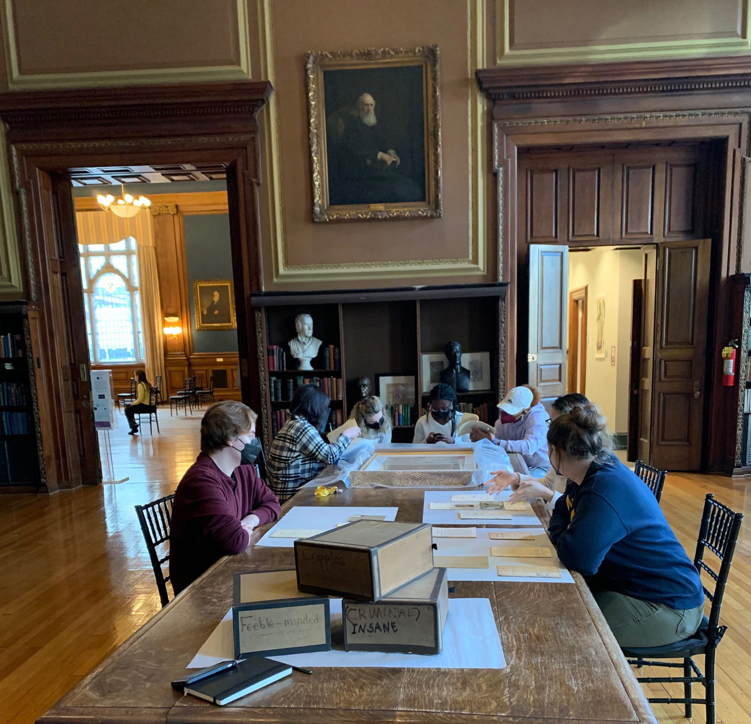 Students studying books at a table in the Mutter Museum.