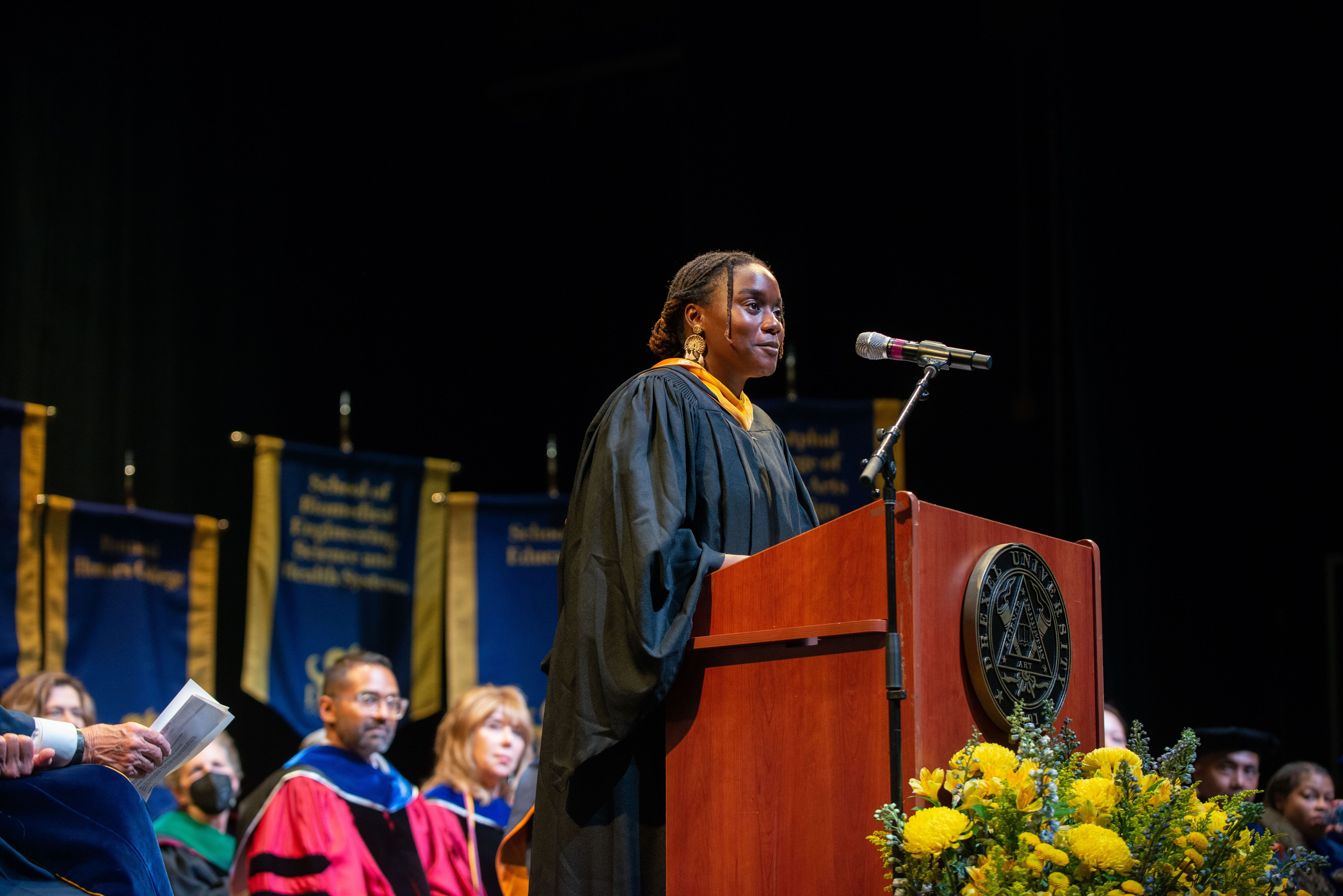 Alexis Wiley stands at the podium at Drexel's 2022 Convocation ceremony. Photo credit: Shira Yudkoff Photography.