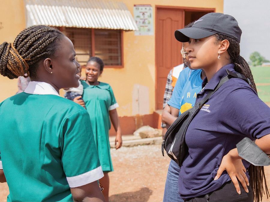 A student talks to a nurse in Ghana
