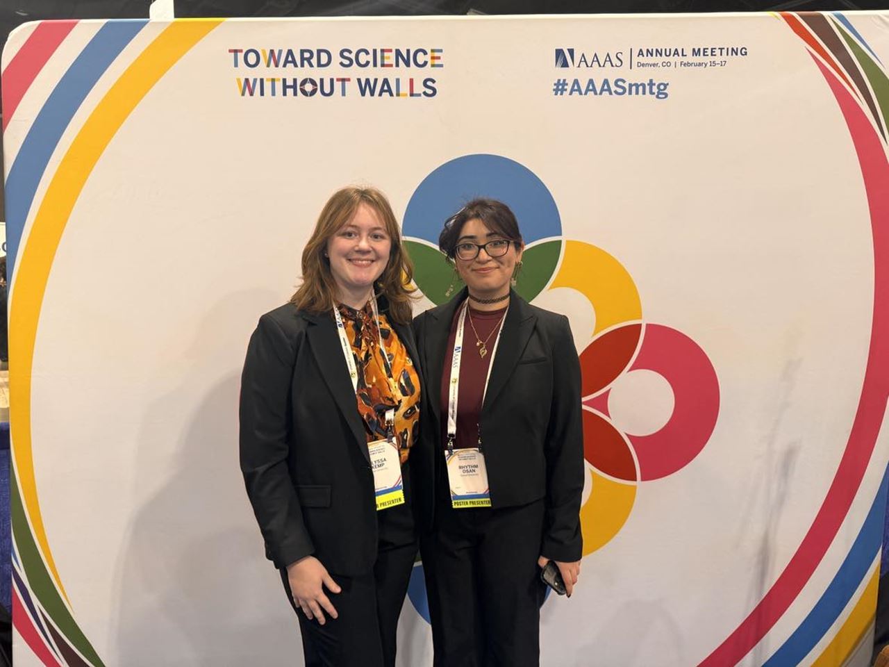 Alyssa Kemp and Rhythm Osan in front of the AAAS 2024 background