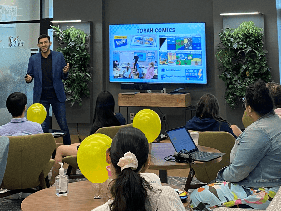 A student presents their research to a crowd