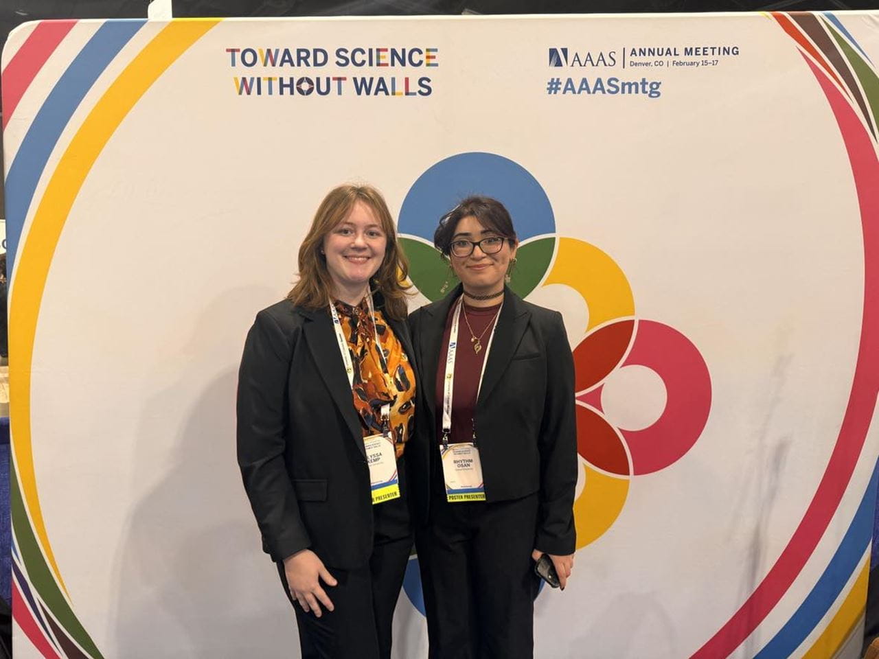 Alyssa Kemp and Rhythm Osan in front of the AAAS 2024 background