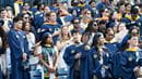 A photo of the crowd of graduates in blue Commencement gowns