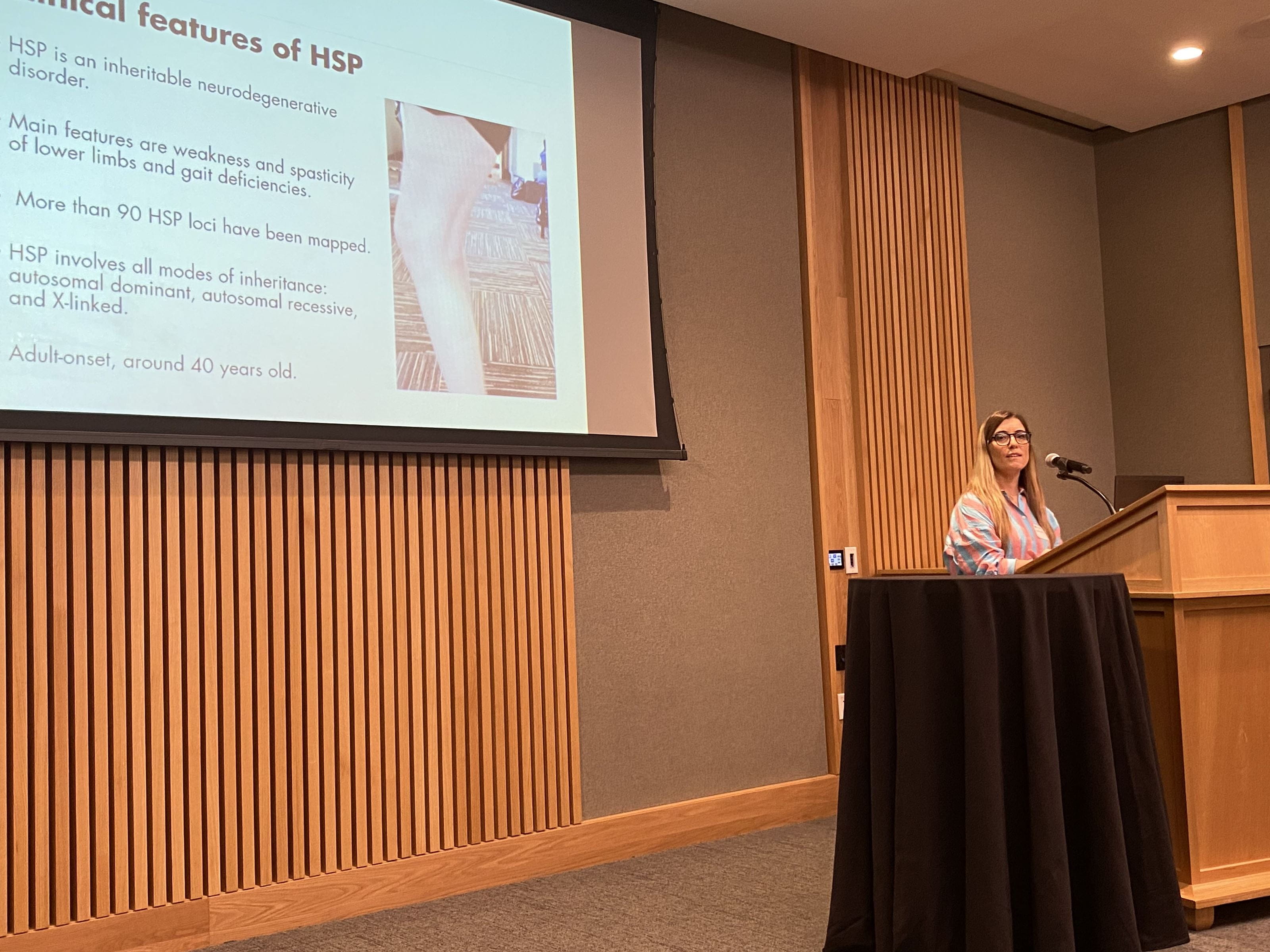 Emanuela Piermarini presenting at the CGT symposium in front of a projection screen