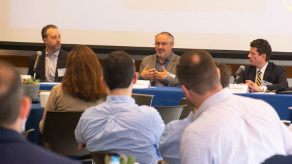 3 Industry experts on Blockchain sitting at a table for panel discussion