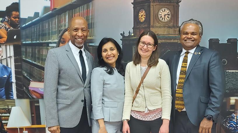 Four people standing in a line 