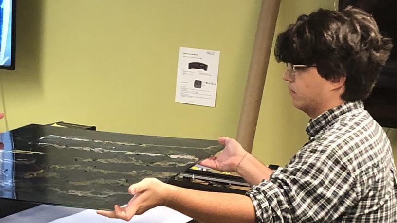 students lifting artwork