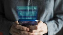 Person typing on phone to AI chatbot.