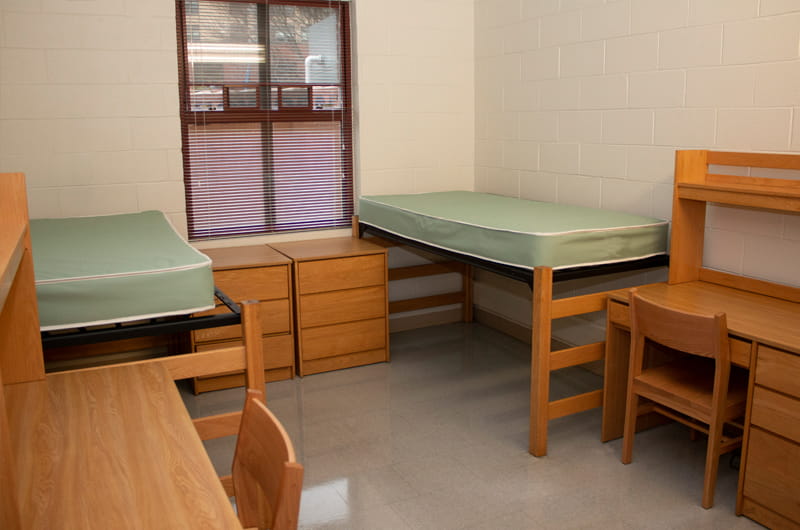north hall interior with two beds and two desks