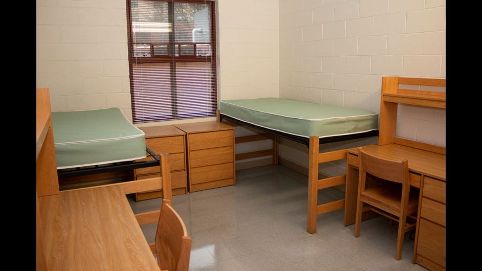 north hall interior with two beds and two desks