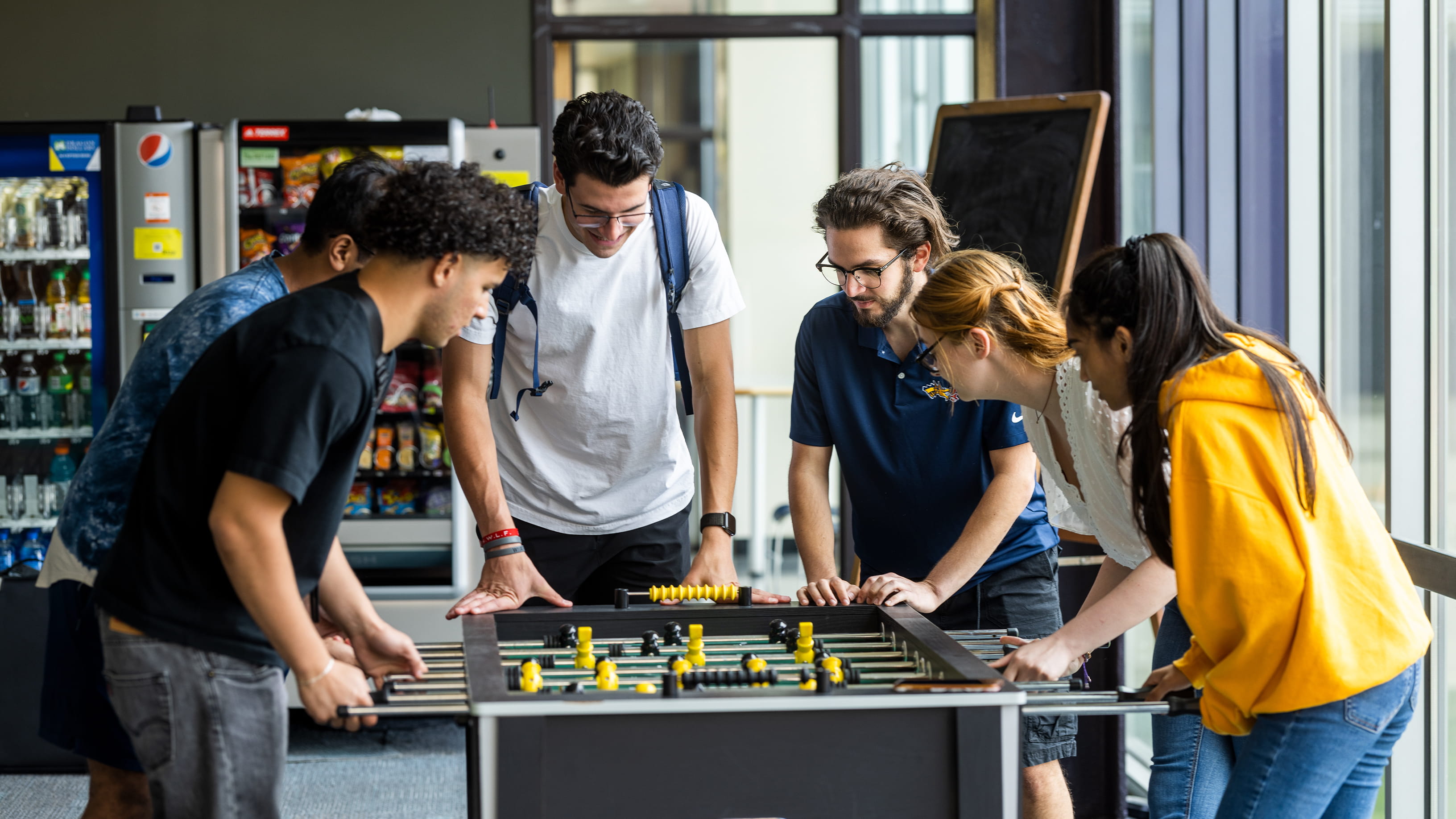 race students around foosball table