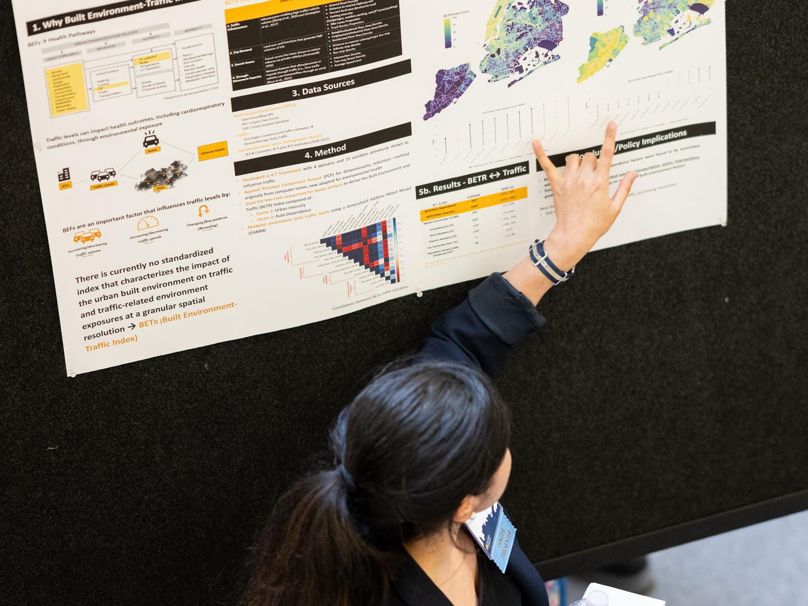 UHC researcher points at data on a research poster