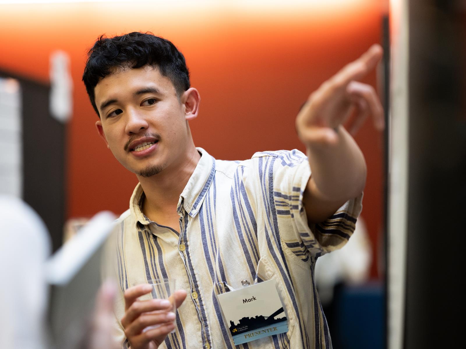 UHC doctoral student discussing their research at poster session