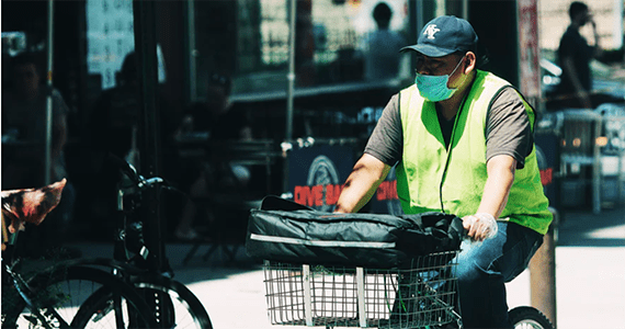 man riding bike down city street