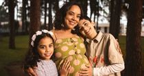 Pregnant mom hugs two children