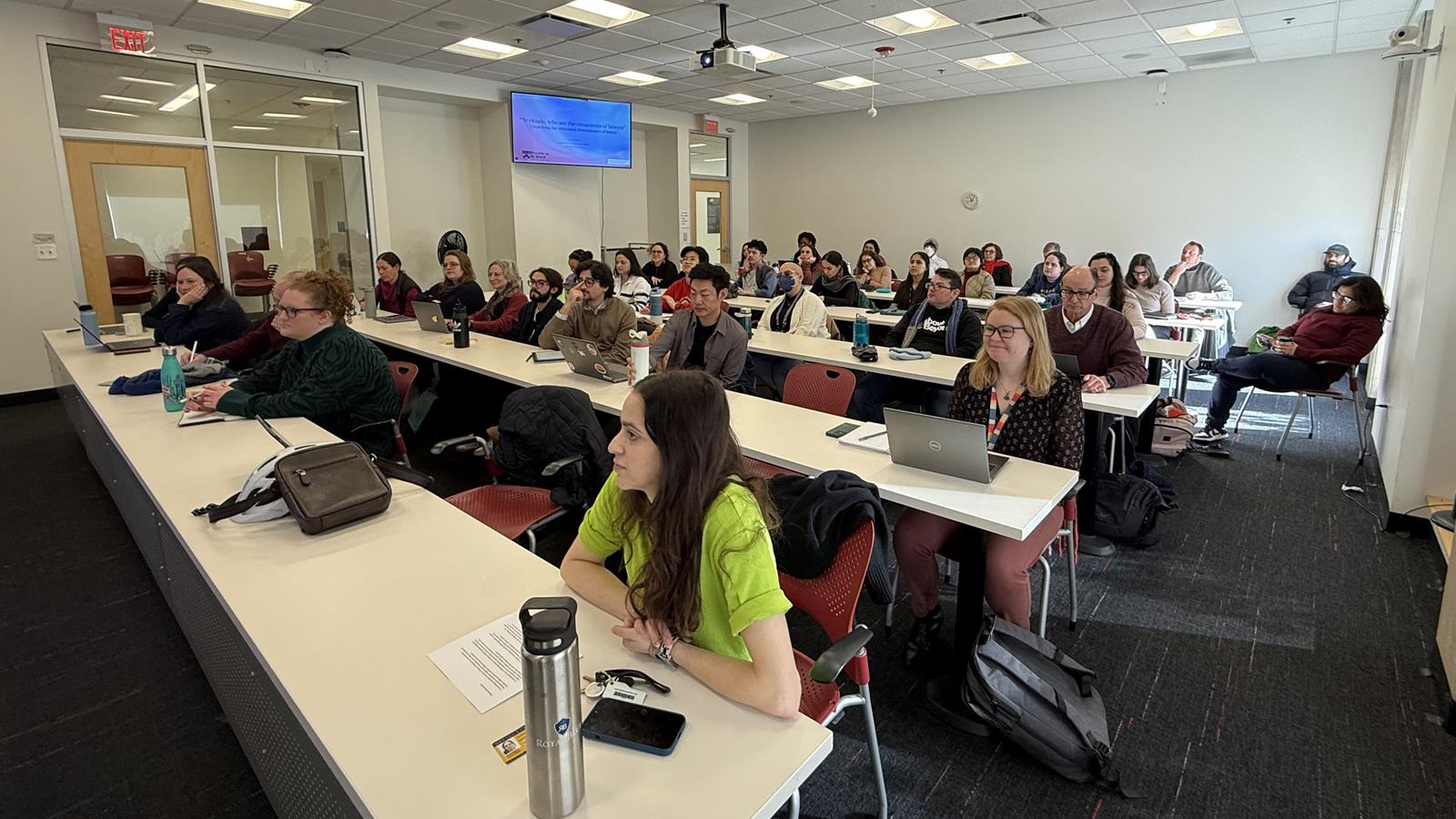 Students viewing a presentation from Dr. Julia Lynch.