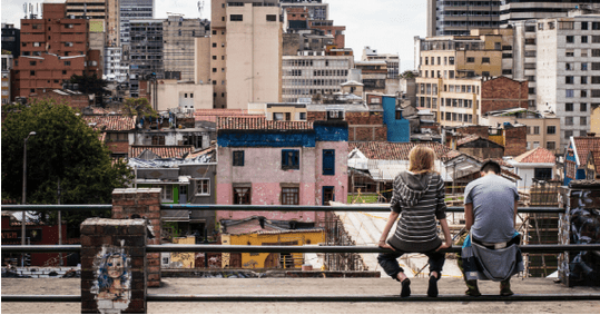 Two people sitting overlooking a city