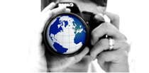 Man using camera that has an image of a globe in the lense