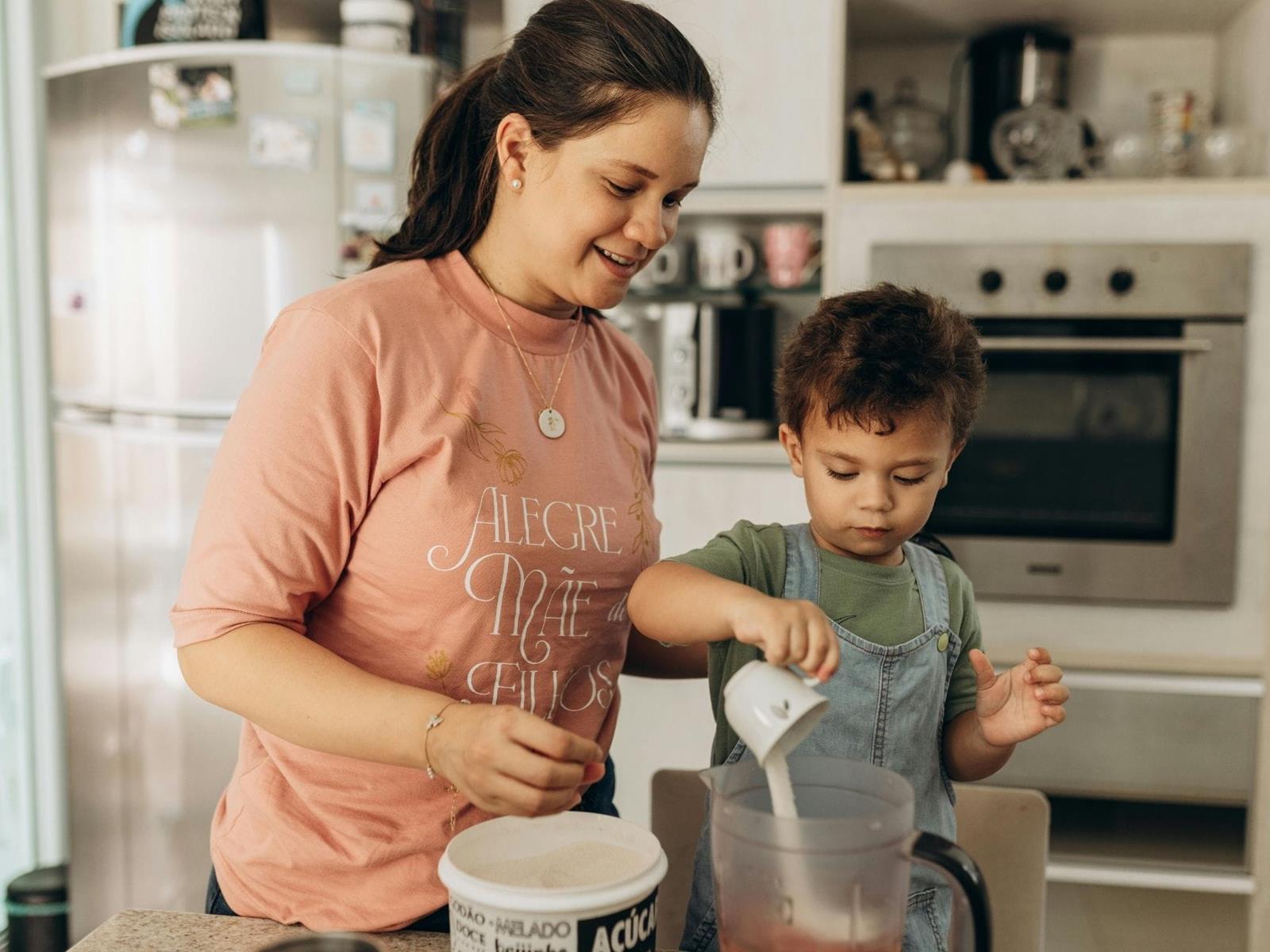 Child helping mother with baking