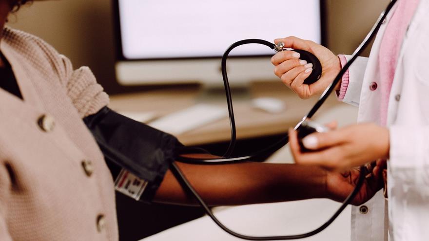 woman having blood pressure taken
