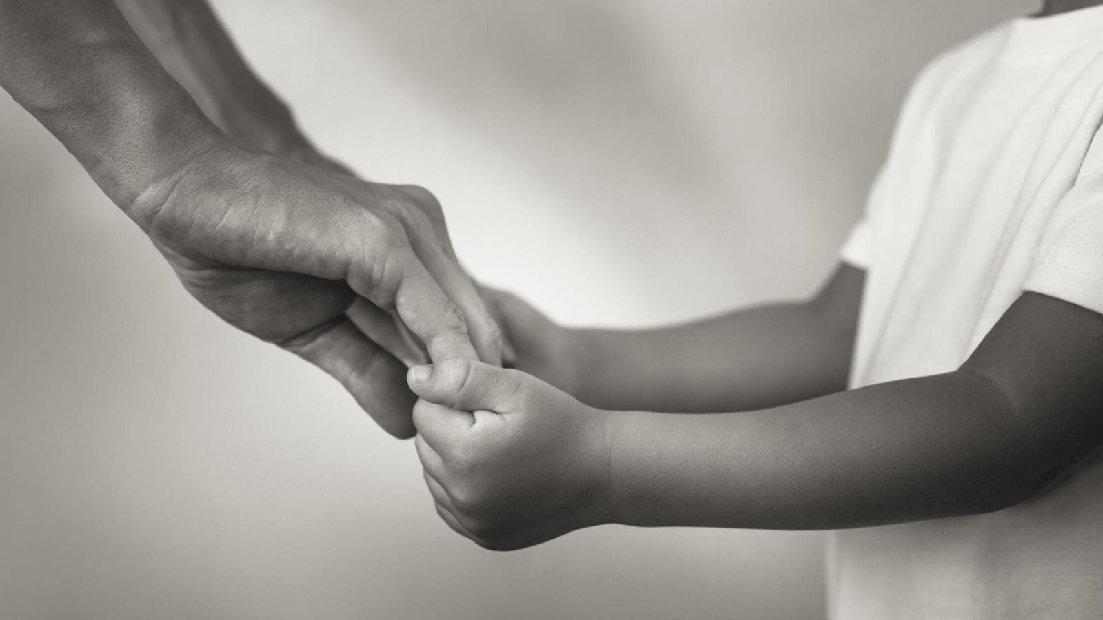 Child holding an adults hands