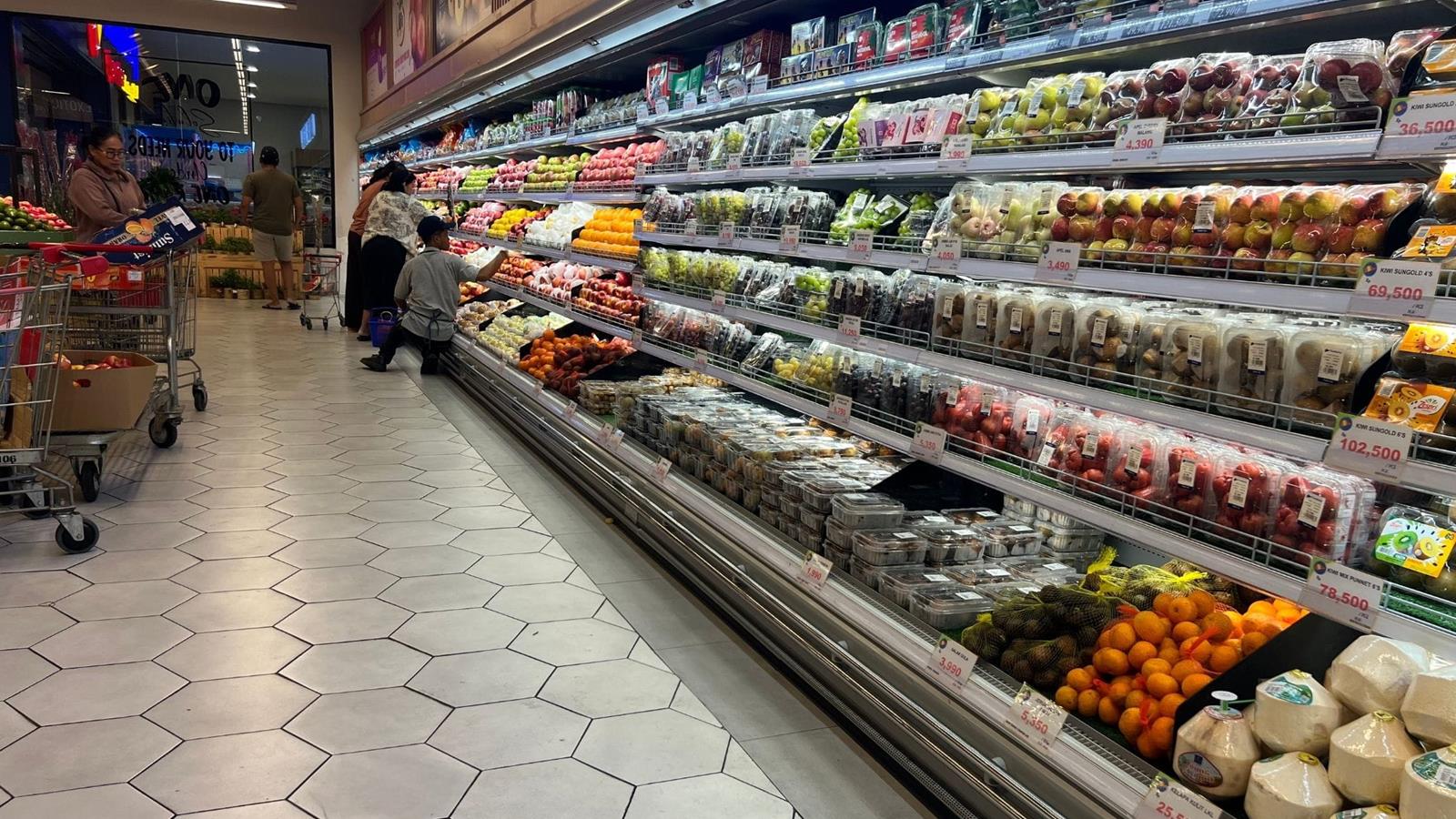 Family shopping for vegetables in grocery store