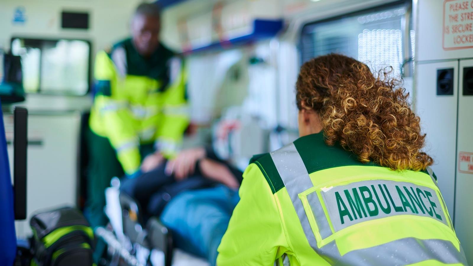 person being lifted into back of an ambulance
