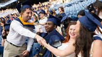 Students shaking hands in the stands