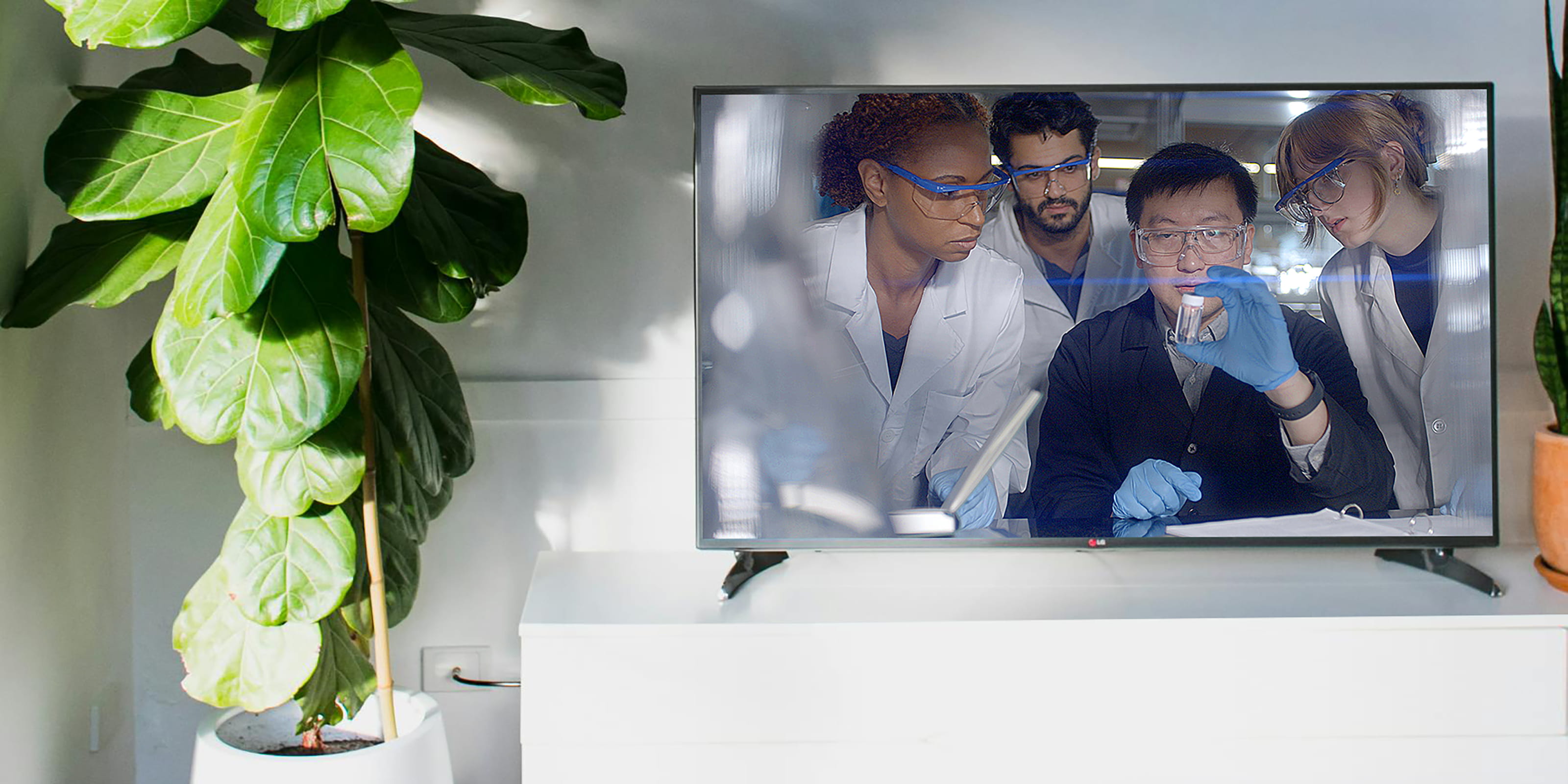 Television screen depicting Drexel students in a laboratory setting
