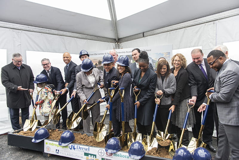 people holding shovels for ground breaking construction