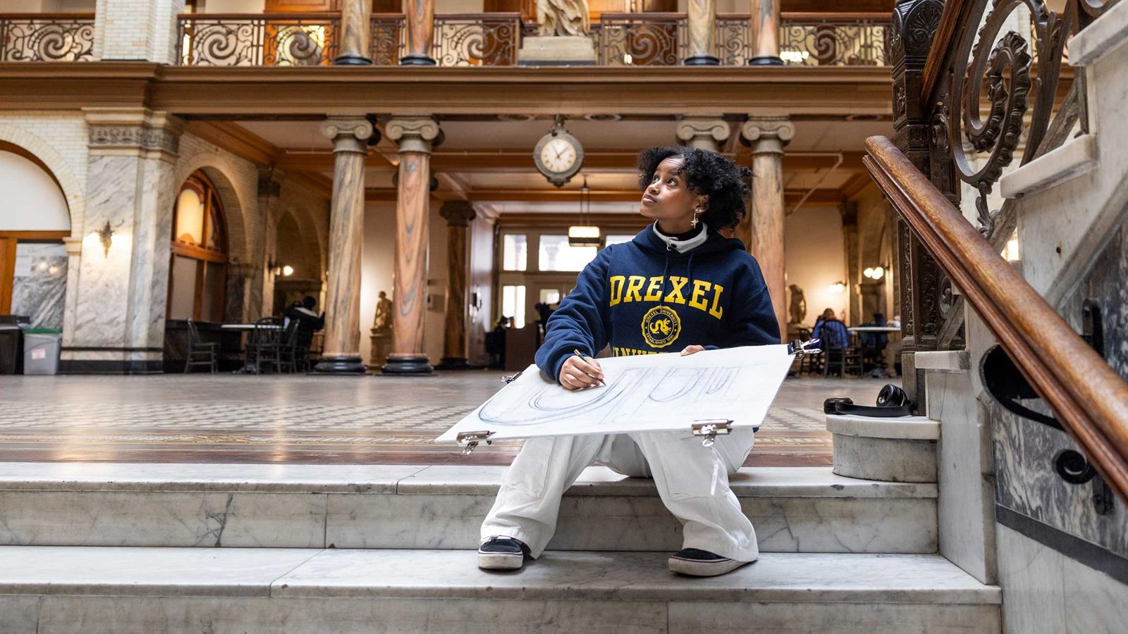 Drexel student sketching in academic building