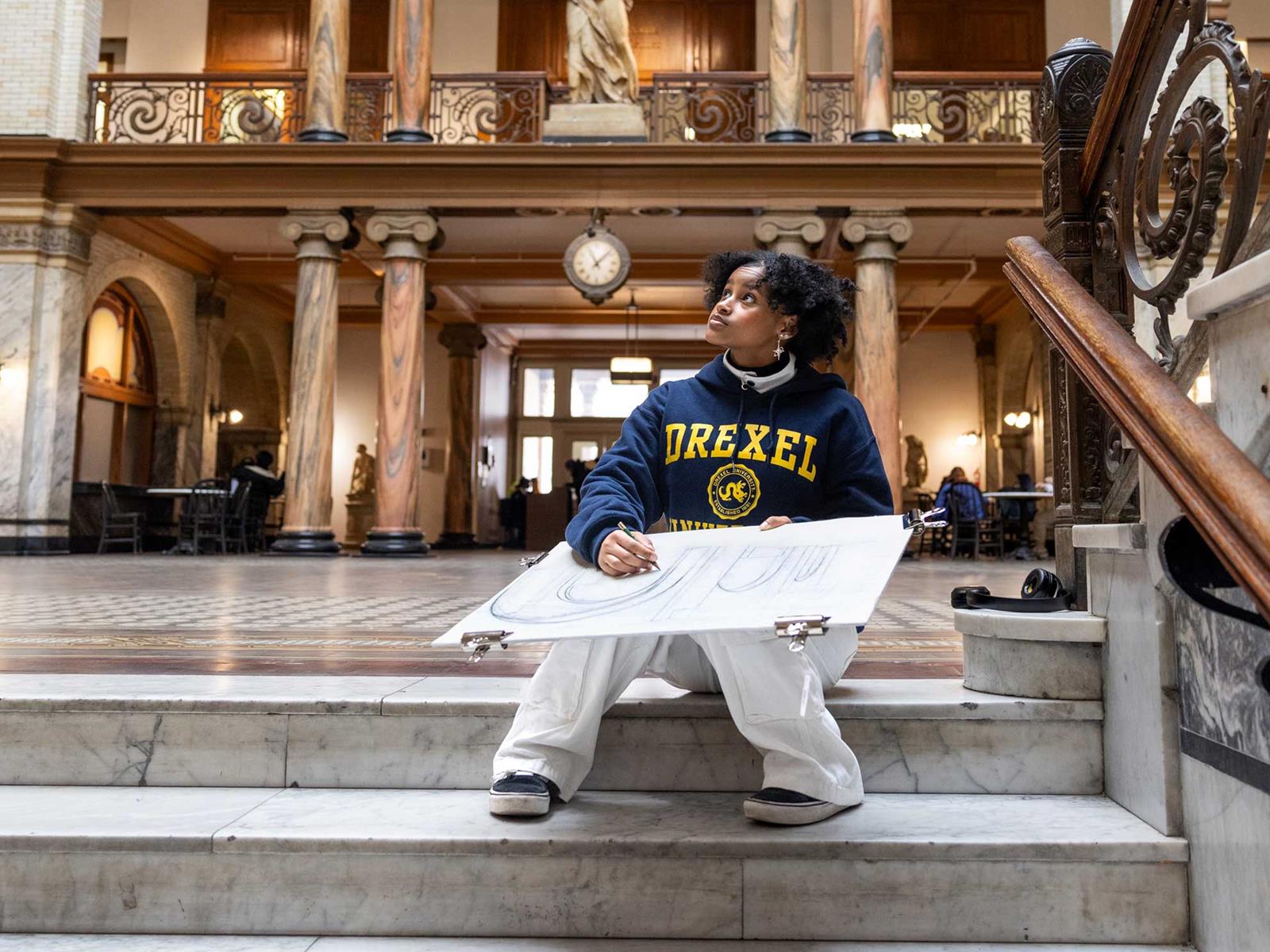 Drexel student sketching in academic building